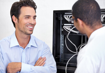 Server room, it support and network with an engineer talking to a business man about cyber security. Database, consulting and maintenance with a technician chatting about information technology