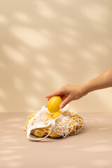 A woman's hand takes a lemon from a bag. Healthy food, ecological products.