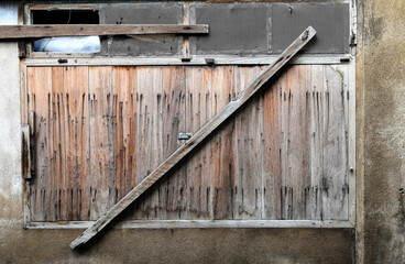 an abandoned, derelict, weathered ancient building with broken windows at countryside.