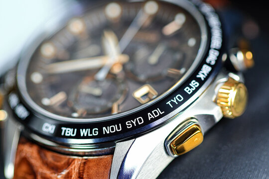 close up shallow focus Time zone cities code on luxury world time  watch bezel, SYD Sydney, ADL Adelaide, NEU Neumea, TYO Tokyo.