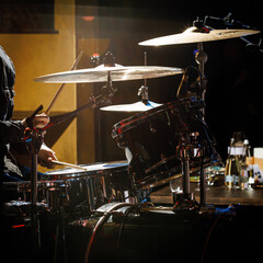 Fototapeta na wymiar Close-up of drummer drumsticks with a drum set.