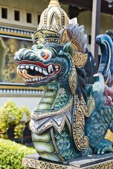 Dragon like statue in Pura Tanah Lot temple in Bali, Indonesia. Colorful wooden carved dragon statue. Dragon (naga) guardian statue at Balinese Hindu temple. Iconic religious landmark of Bali. 
