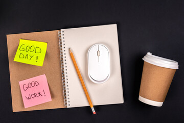 Notebook, disposable paper cup, computer mouse and paper sticker, top view.