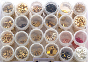 box with beads. handicraft items, jewelry, beads, DIY background. Plastic acrylic glass beads of different shapes and colors for making brooches, pendants, collars. Blur effect. Weak focus.