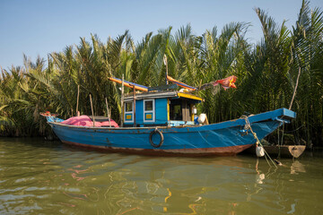 Fototapeta na wymiar Old boat in the coconut forest in Hoi An, Vietnam