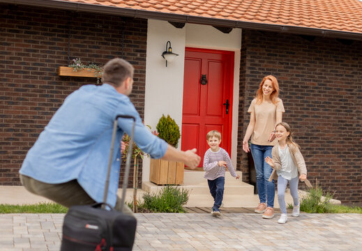 Father came home from the trip and son, daughter and wife running to meet him