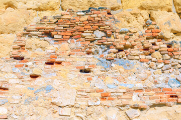 Brick ruined wall . Old stones wall background