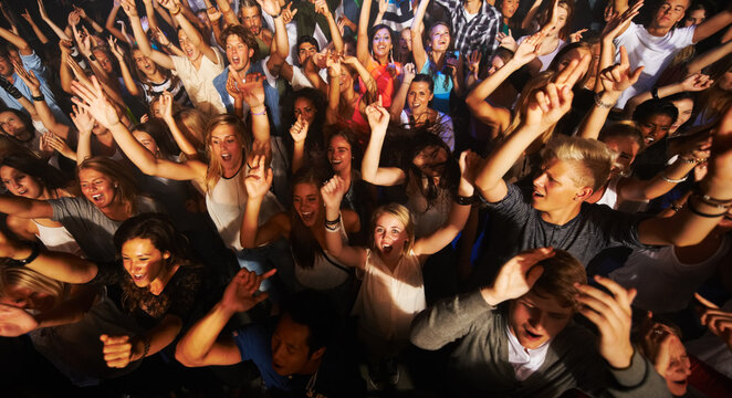 Music, dance and party with crowd at concert for rock, live band performance or festival. New year, energy and disco with audience of fans listening at celebration for techno, rave or nightclub event