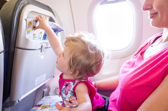 Mother travelling with small one year old child on an airplane