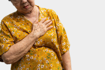 Elderly woman feels pain in her chest. Senior female Asian suffering from bad pain in his chest...