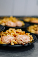 many plate with chicken meat burger cutlets with pasta