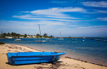 Boat on the Ria Formosa empty beach  in Algarve Portugal