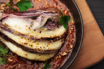 Fried eggplant with tomatoes in a pan
