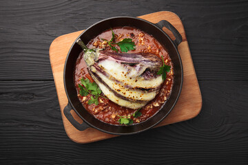 Fried eggplant with tomatoes in a pan