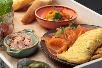 A variety of snacks with red fish, sauce, spices
