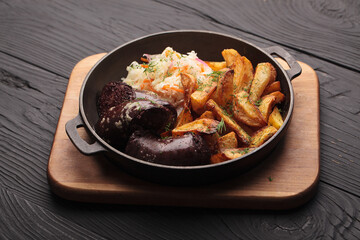 Fried blood sausages with potatoes and various ingredients