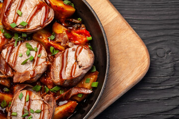 Fried blood sausages with potatoes and various ingredients