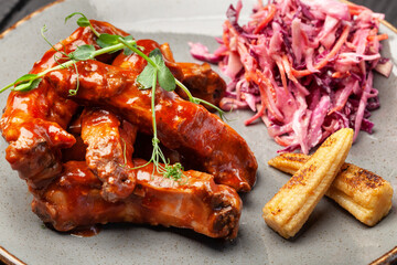 Fried juicy meat beef on a plate with sauce and spices