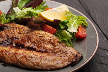 Fried juicy meat beef on a plate with sauce and spices