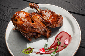 Fried juicy chicken meat on a plate with sauce and spices