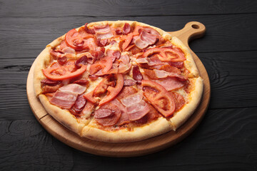 Italian or French pizza with different ingredients. Sausage, meat, cheese, tomatoes.