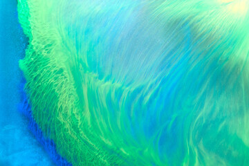 Abstract green color background. Multicolored fluid art. Waves, splashes and blots acrylic alcohol ink, paints under water