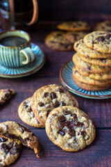 freshly baked homemade chocolate chip cookies on wooden background.