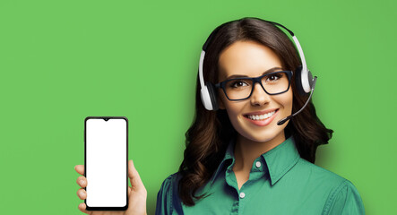 Customer support phone operator in glasses and headset holding showing smartphone cellphone mobile...