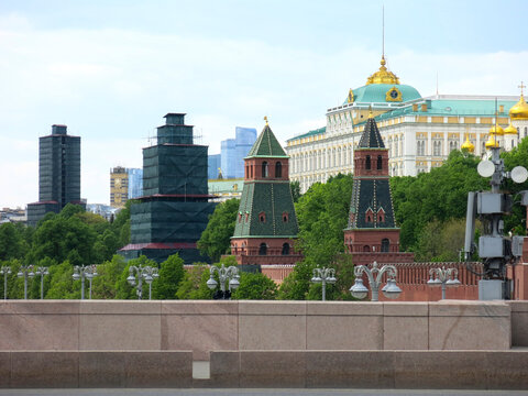 the towers of the walls of the Moscow Kremlin made of red brick, in the background the Senate Palace and the bell tower of Ivan the Greatof the Russian Federation and the bell tower of Ivan the Great