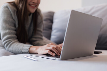 Attractive Asian woman resting comfortable living room and using laptop computer, Relax, Sofa, Lifestyle