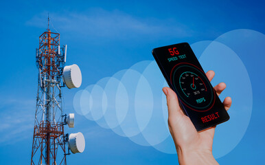 Hands with a phone on the background of 5G cell towers receiving a signal