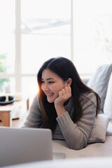 Attractive Asian woman resting comfortable living room and using laptop computer, Relax, Sofa, Lifestyle