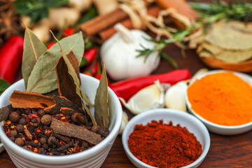 Food, leaf and spices on table top for cooking meal, turmeric seasoning or paprika flavor. Vegetables, kitchen condiments and variety of plant herbs in bowls for brunch, healthy diet or vitamins.