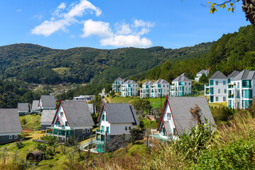 Many similar houses against lake and mountains in Da Lat Vietnam