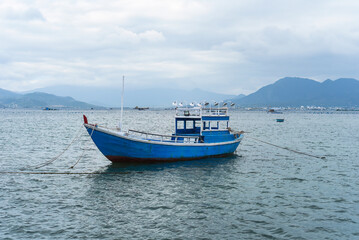 Vietnamese blue boat swimming in south china sea in vietnam 