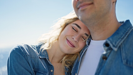 Man and woman couple standing together breathing at seaside