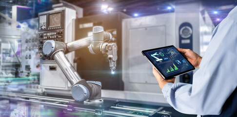 Smart industry control concept.Manager Engineer Hands holding tablet on blurred automation machine...
