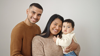Fototapeta premium Couple and son hugging each other standing over isolated white background
