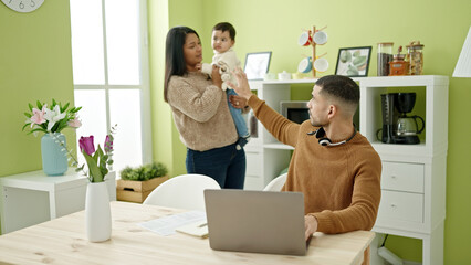 Couple and son taking care of son asking for silent working at home