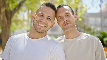 Fototapeta premium Two men couple smiling confident standing together at park