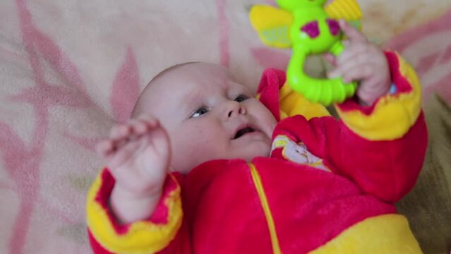 Baby  Playing With A Rattle Toy,baby girl holding toy teether