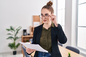 Young woman business worker reading document at office
