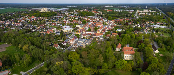 Aerial around the old town of the city Vetschau on a sunny spring day