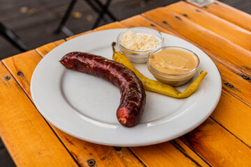 Typical Czech snack - sausage with mustard and horseradish