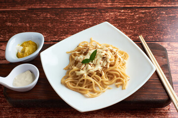 spaghetti with little tomato, using chopsticks