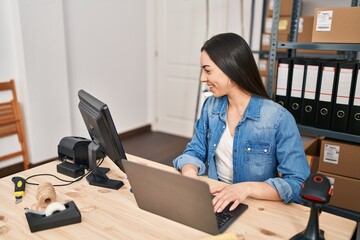 Young beautiful hispanic woman ecommerce business worker using laptop at office