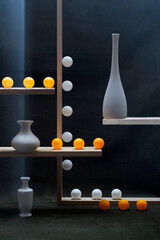 Geometric still life with white and orange balls and white vases