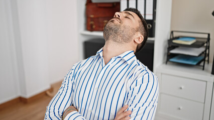 Fototapeta premium Young hispanic man business worker sleeping at office