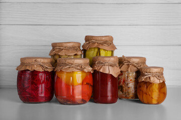 Many jars with different preserved products on light grey table