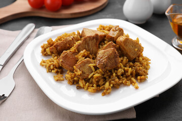 Delicious rice with chicken served on table, closeup